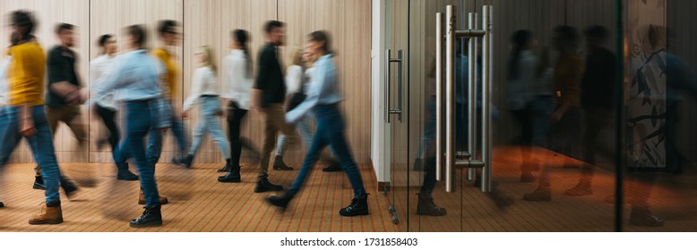 Group of business people walking at office openspace. Team of business employees at coworking center. People at motion blur. Concept working at action. Wide image