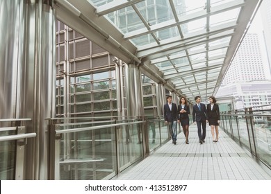 Group Of Business People Walking At Street