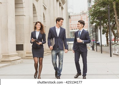 Group Of Business People Walking At Street