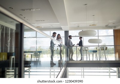 Group of business people walking and taking at stairs in an office - Powered by Shutterstock