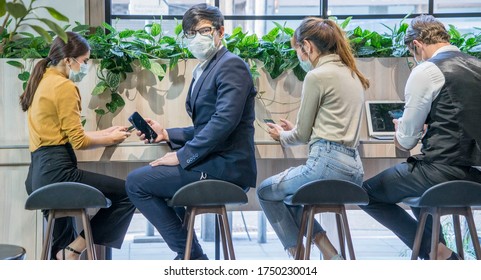 Group Of Business People Workers Talking Together With Laptop And Wear Protective Masks Prevent  Corona Virus Or Covid 19 At Co Working Space Modern Office .Health And Teamwork Concept.