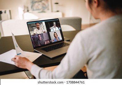 Group Of Business People Working From Home, Having Video Conference. Businesswoman Having A Video Call With Her Team Over A Laptop At Home.