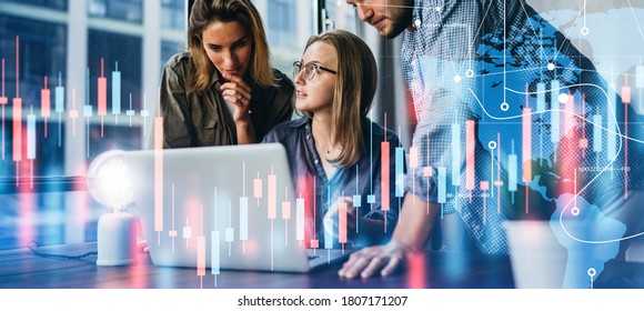 Group of business people working at modern office.Technical price graph, red and blue candlestick chart and stock trading computer screen background. Double exposure. Traders analyzing data