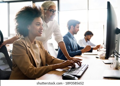 Group of business people working together, brainstorming in office - Shutterstock ID 1893585652