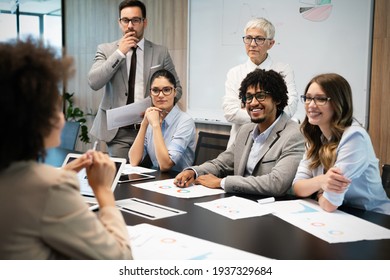 Group of business people working together, brainstorming in office - Shutterstock ID 1937329684
