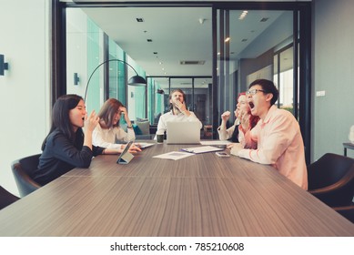 Group Of Business People Yawning In A Meeting Room, Sharing Their Ideas, Multi Ethnic