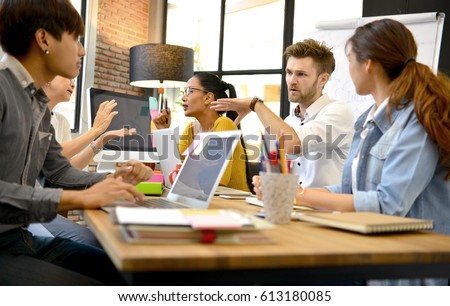 Group of business persons having different age in creative business discussing work in the office