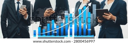 A group of business professionals engaged in data analysis, using smartphones and tablets, with a striking growth chart visual enhancing the modern office environment. Amity