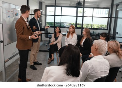 A group of business professionals gather in a contemporary office environment for a strategy meeting. Participants share ideas and insights, showcasing collaboration in an open, bright setting.