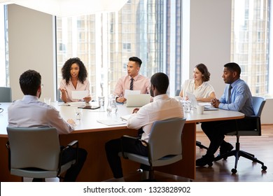 Group Of Business Professionals Meeting Around Table In Modern Office