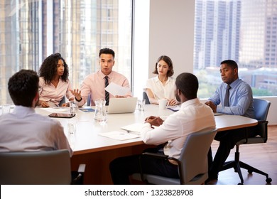 Group Of Business Professionals Meeting Around Table In Modern Office