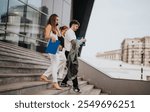 Group of business professionals walking down steps outside an office building, holding documents and having a conversation.