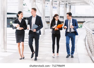 Group Of  Business Team Walking At Street