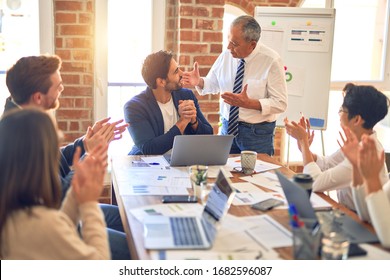 Group Of Business Workers Smiling Happy And Confident. Working Together With Smile On Face Applauding One Of Them At The Office