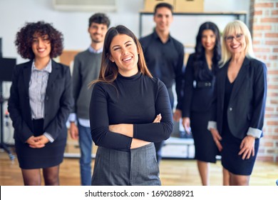Group of business workers smiling happy and confident. Posing together with smile on face looking at the camera, young beautiful woman with crossed arms at the office - Shutterstock ID 1690288921