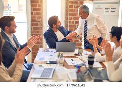 Group of business workers smiling happy and confident. Working together with smile on face applauding one of them at the office - Shutterstock ID 1779411842