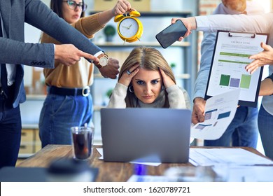 Group of business workers working together. Partners stressing one of them at the office - Powered by Shutterstock