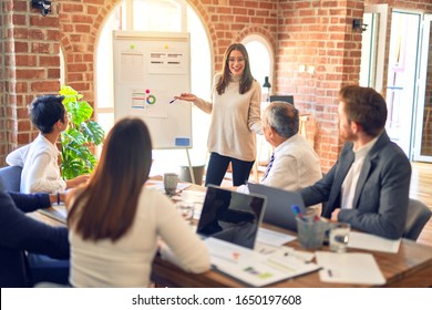 Group of business workers working together in a meeting. One of them making presentation to colleagues at the office - Powered by Shutterstock