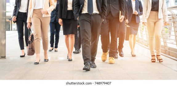 Group of businessman and businesswoman walking in modern city, successful business team. - Shutterstock ID 748979407
