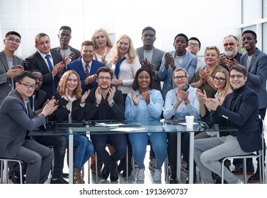 a group of businessmen applaud each other, emphasizing their suc - Powered by Shutterstock