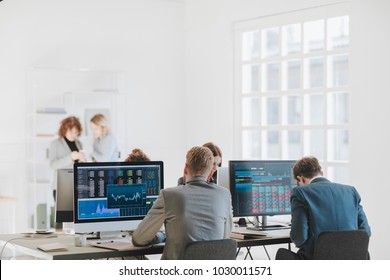 Group Of Businessmen And Businesswomen Stock Brokers Working At Office.