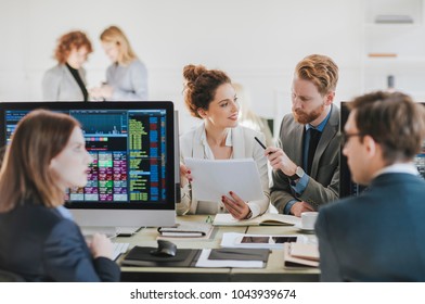 Group Of Businessmen And Businesswomen Stock Brokers Working At Office.