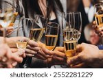 Group of businessmen celebrate, closing successful concluded deal, guests clinking raise glasses with alcohol, sparkling wine, toasting and cheering, colleagues team in office on corporate party event