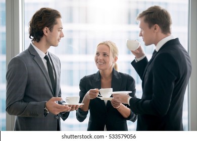 Group of businessmen having tea in office after meeting, provide good employment conditions for employees, co-working space, surrounding with right people. Enjoy coffee break concept. Focus on woman