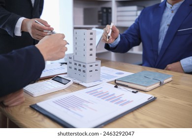group of businessmen and investors discuss investing in real estate and jointly plan investments in construction projects of condominiums and apartments for sale and rent. investment advisory concept