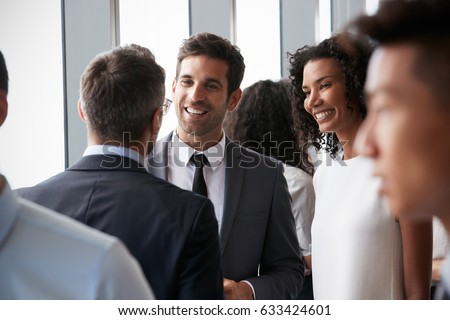 Group Of Businesspeople Having Informal Office Meeting
