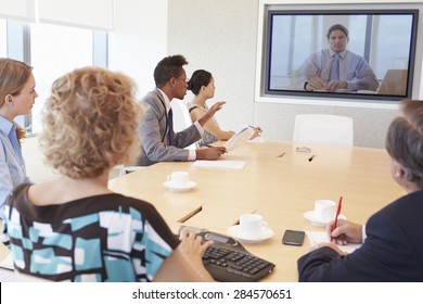 Group Of Businesspeople Having Video Conference In Boardroom