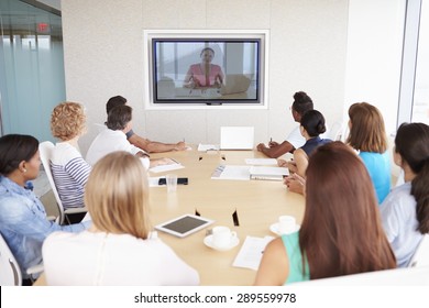 Group Of Businesspeople Having Video Conference In Boardroom