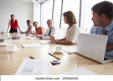 Group Of Businesspeople Meeting Around Boardroom Table - Shutterstock ID 290606438