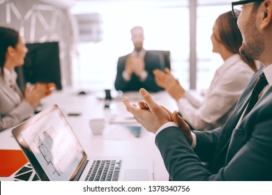 Group Of Businesspeople Sitting At Boardroom At Meeting And Clapping. Get Into The Habit Of Asking Yourself If What You Are Doing Can Be Handled By Someone Else.