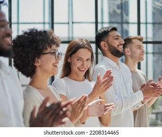 Group of businesspeople sitting in a line and applauding. - Shutterstock ID 2208314465