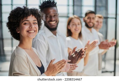 Group of businesspeople sitting in a line and applauding. - Shutterstock ID 2208314467