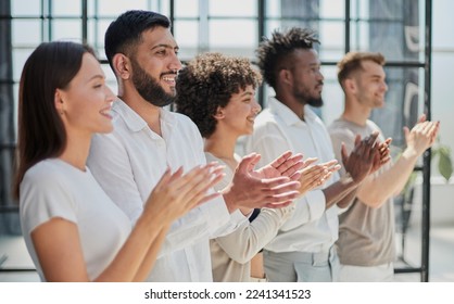 Group of businesspeople sitting in a line and applauding. - Shutterstock ID 2241341523