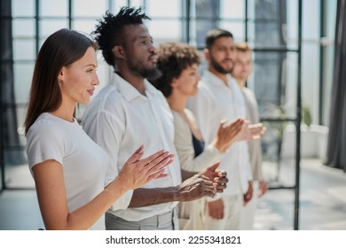 Group of businesspeople sitting in a line and applauding. - Shutterstock ID 2255341821