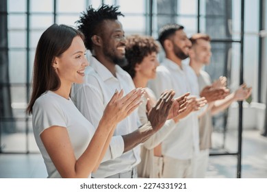 Group of businesspeople sitting in a line and applauding. - Shutterstock ID 2274331921