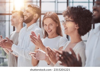 Group of businesspeople sitting in a line and applauding. - Shutterstock ID 2315201221