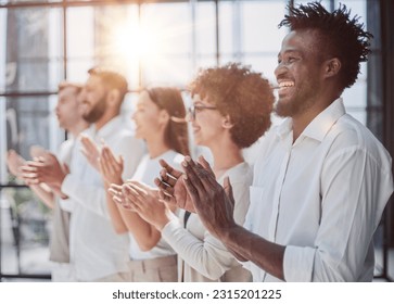 Group of businesspeople sitting in a line and applauding. - Shutterstock ID 2315201225