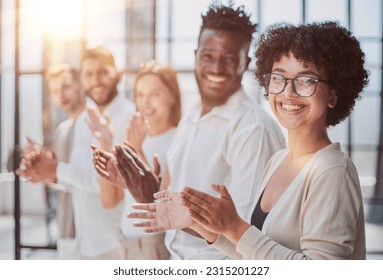 Group of businesspeople sitting in a line and applauding. - Shutterstock ID 2315201227