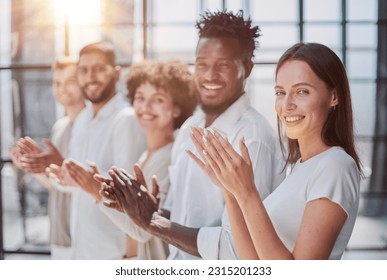 Group of businesspeople sitting in a line and applauding. - Shutterstock ID 2315201233
