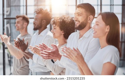 Group of businesspeople sitting in a line and applauding. - Shutterstock ID 2315201235