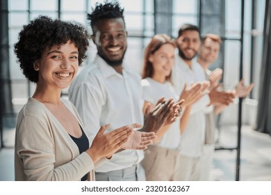 Group of businesspeople sitting in a line and applauding. - Shutterstock ID 2320162367