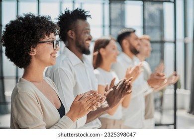 Group of businesspeople sitting in a line and applauding. - Shutterstock ID 2325398047
