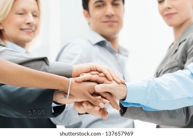 Group Of Businesspeople With Stacked Hands Showing Unity and Teamwork