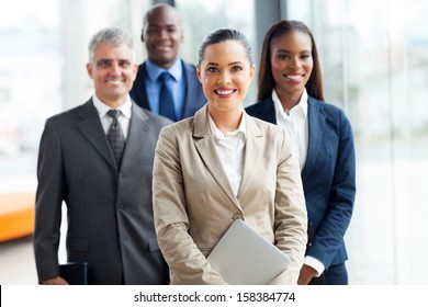 group of businesspeople standing together in office