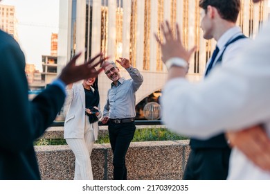 A Group Of Businesspeople Are Waving Each Other Goodbye As They're Leaving