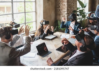 Group of businessperson brainstorming on a virtual project wearing 360 3d vr goggles and sitting around the table - people meets in metaverse reality - business lifestyle concept - Shutterstock ID 2181095747